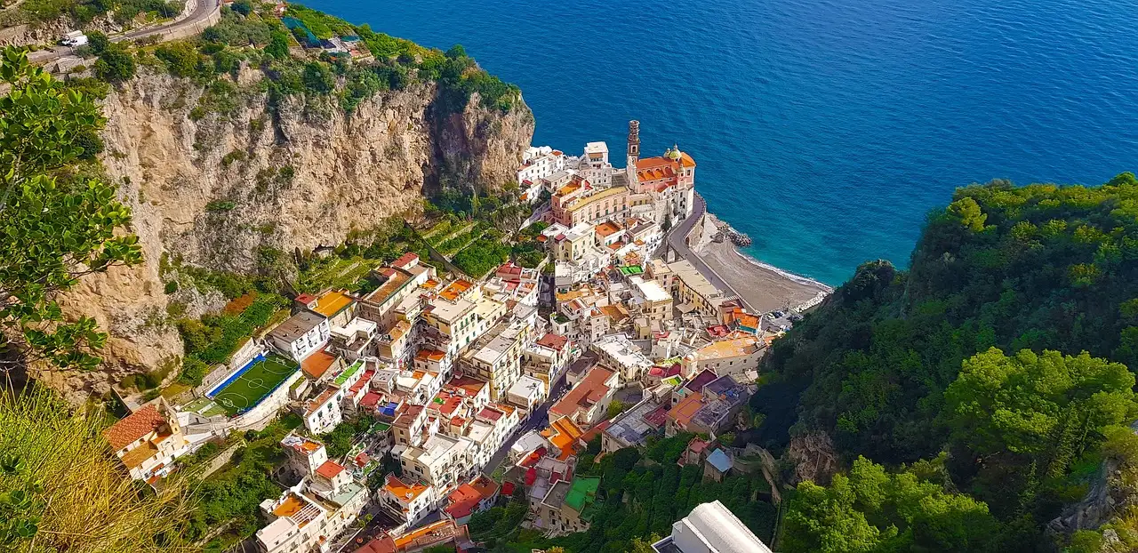 A town between steep cliffs on the Amalfi Coast, seen from above
