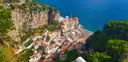 A town between steep cliffs on the Amalfi Coast, seen from above