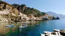 Small boats in the bay at Amalfi, with the town on the cliffs