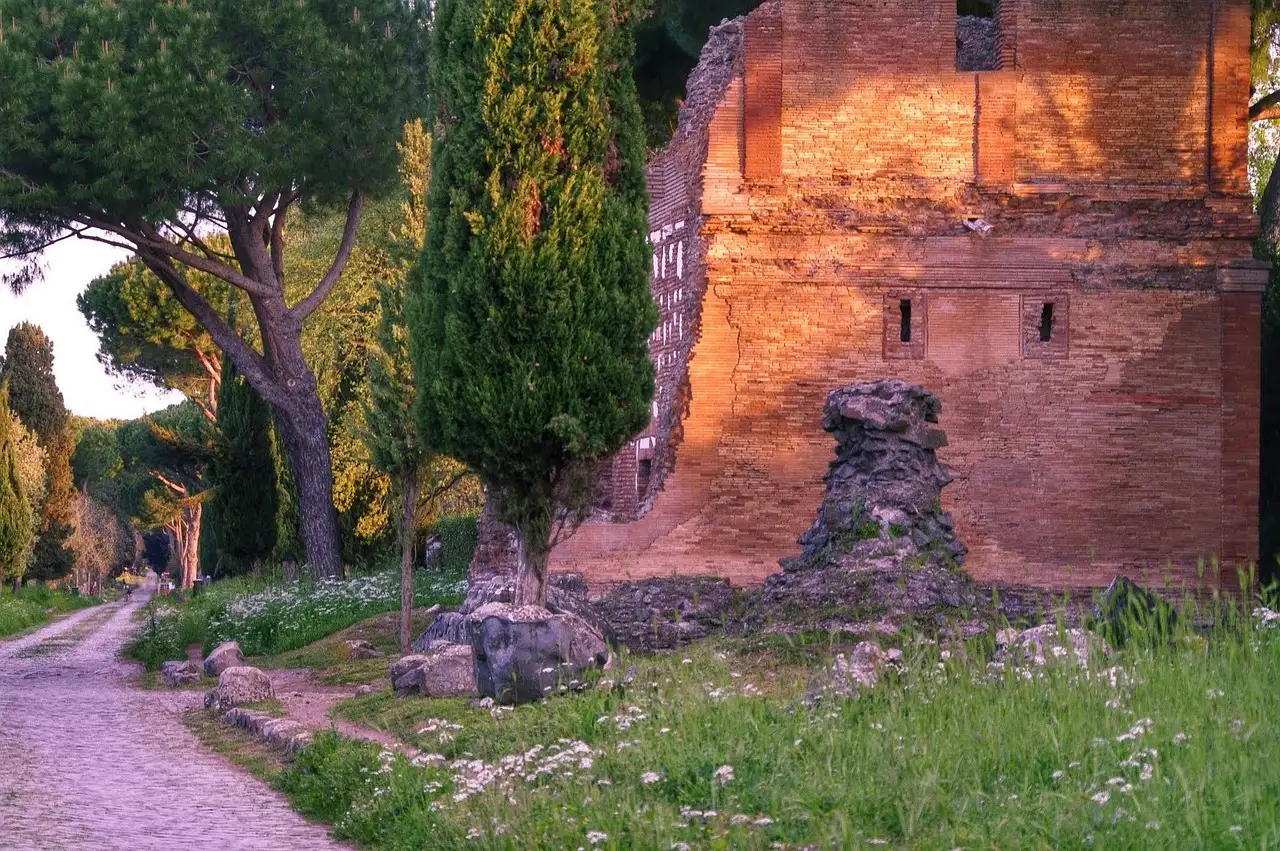 A brick Roman tomb beside the Appian Way, lit by low sun