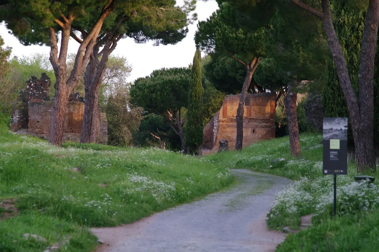 The old Appian Way in Rome, a quiet road between pine trees and ancient ruins
