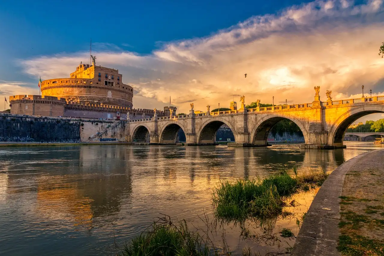 Castel Sant'Angelo and its stone bridge over the Tiber in golden evening light
