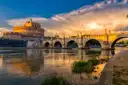 Castel Sant'Angelo and its stone bridge over the Tiber in golden evening light