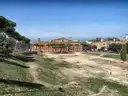 The long grassy track of the Circus Maximus, with trees and buildings beyond