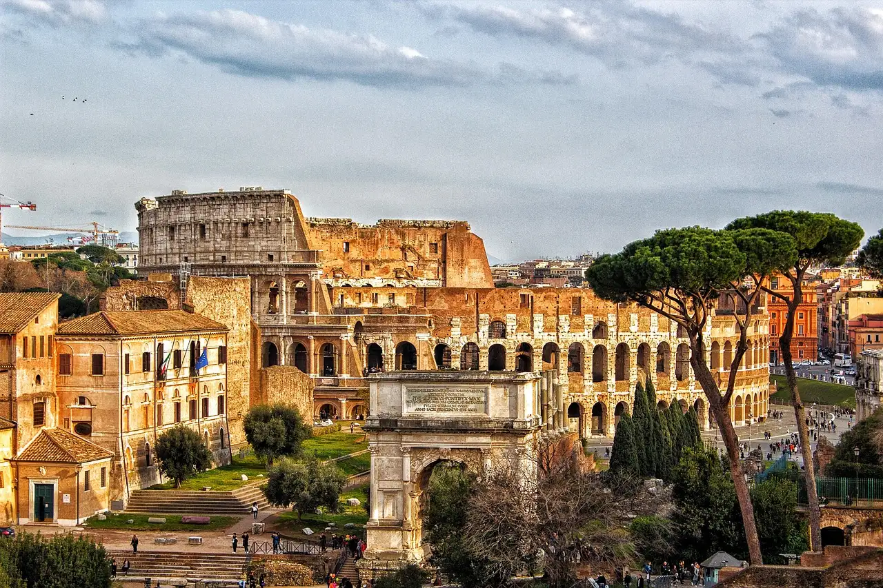 The Colosseum and the Arch of Constantine seen from the Palatine side, with pine trees