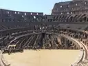 The arena floor platform inside the Colosseum, with the old chambers beyond it
