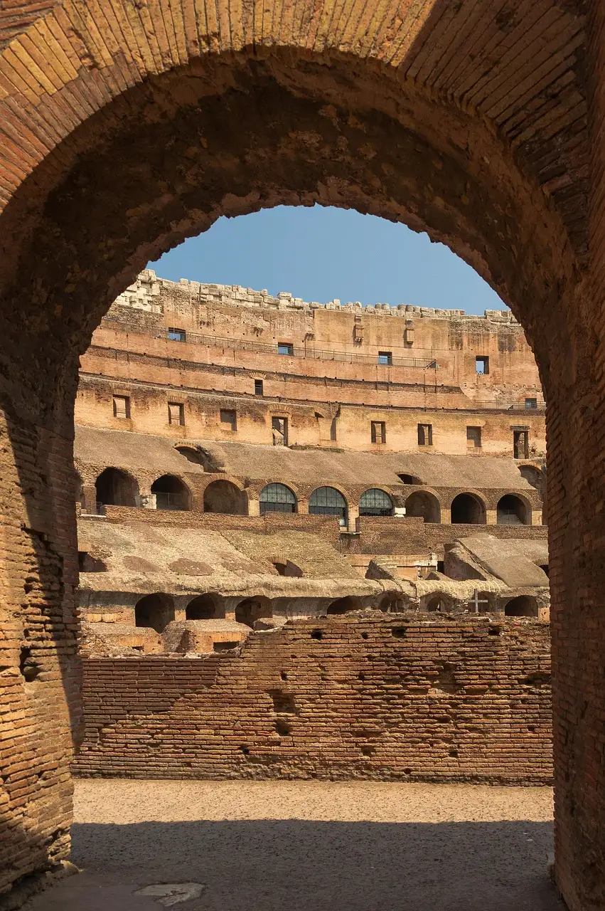 The Colosseum interior seen through a brick archway