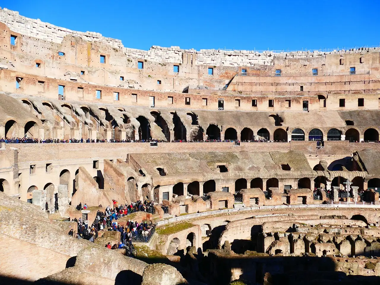 Sunlit tiers of seating inside the Colosseum