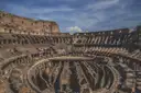 The underground passages of the Colosseum seen from the stands, under a cloudy sky