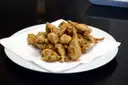 Golden fried artichokes on a white plate