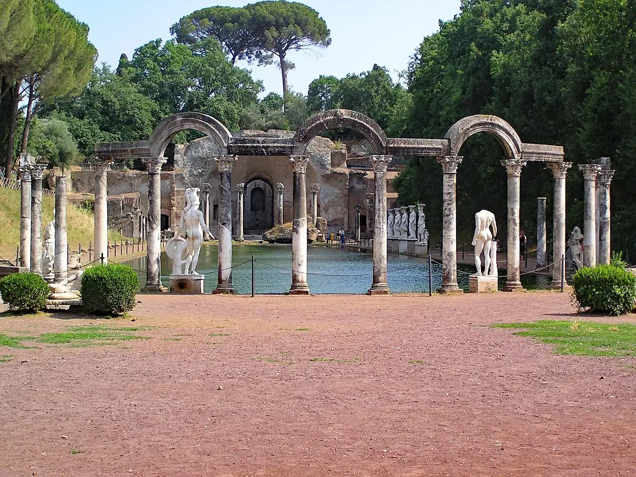 Statues and arches around the long pool of the Canopus at Hadrian's Villa