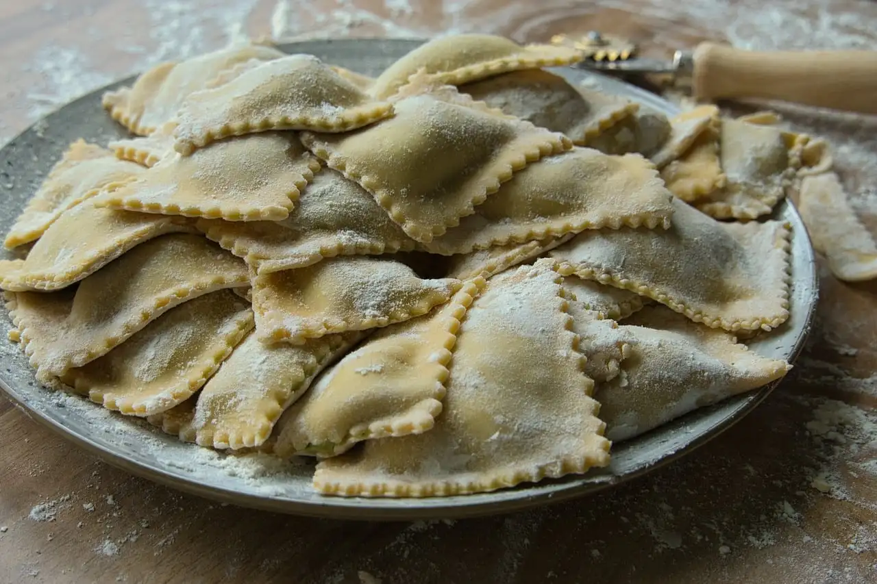 Homemade ravioli on a dark plate