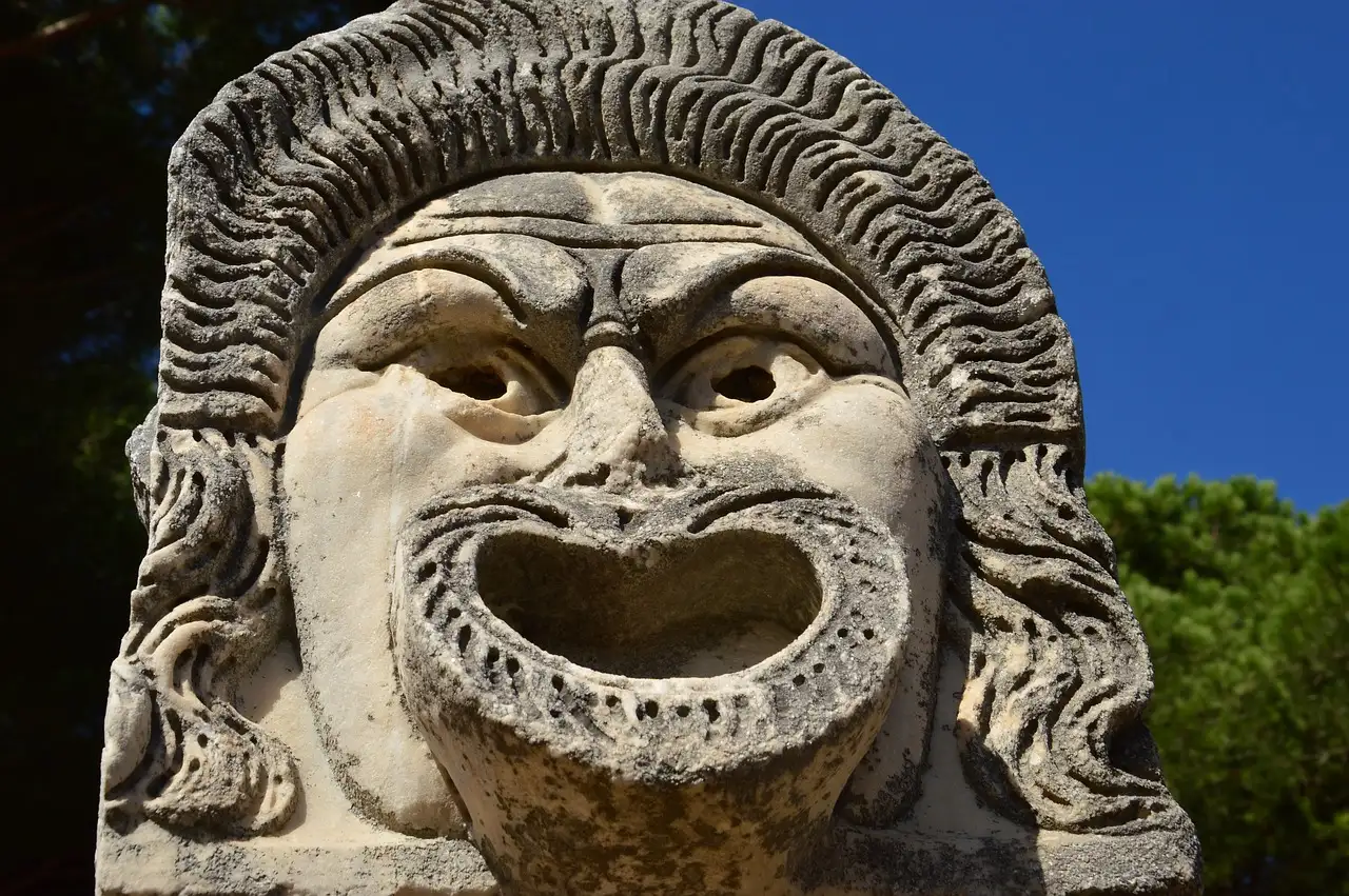 A large stone theatre mask with an open mouth at Ostia Antica