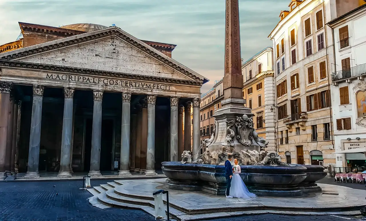 A bride and groom by the fountain in front of the Pantheon at dawn