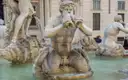 A marble sea god in a fountain on Piazza Navona