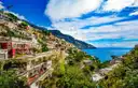 Colorful houses of Positano on the green hillside above the sea