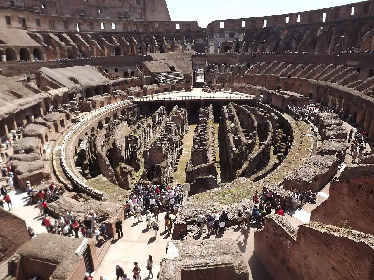 Visitors looking down into the arena floor and tunnels of the Colosseum