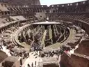 Visitors looking down into the arena floor and tunnels of the Colosseum