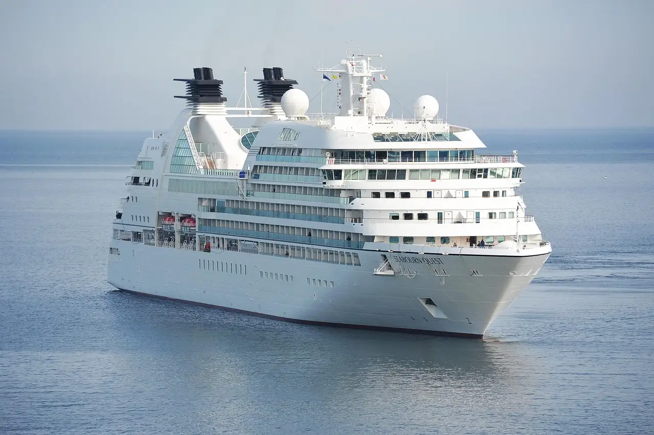 A white cruise ship sailing on calm blue sea
