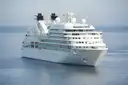 A white cruise ship sailing on calm blue sea