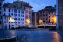 Bicycles parked by a fountain in a quiet Rome square at dawn