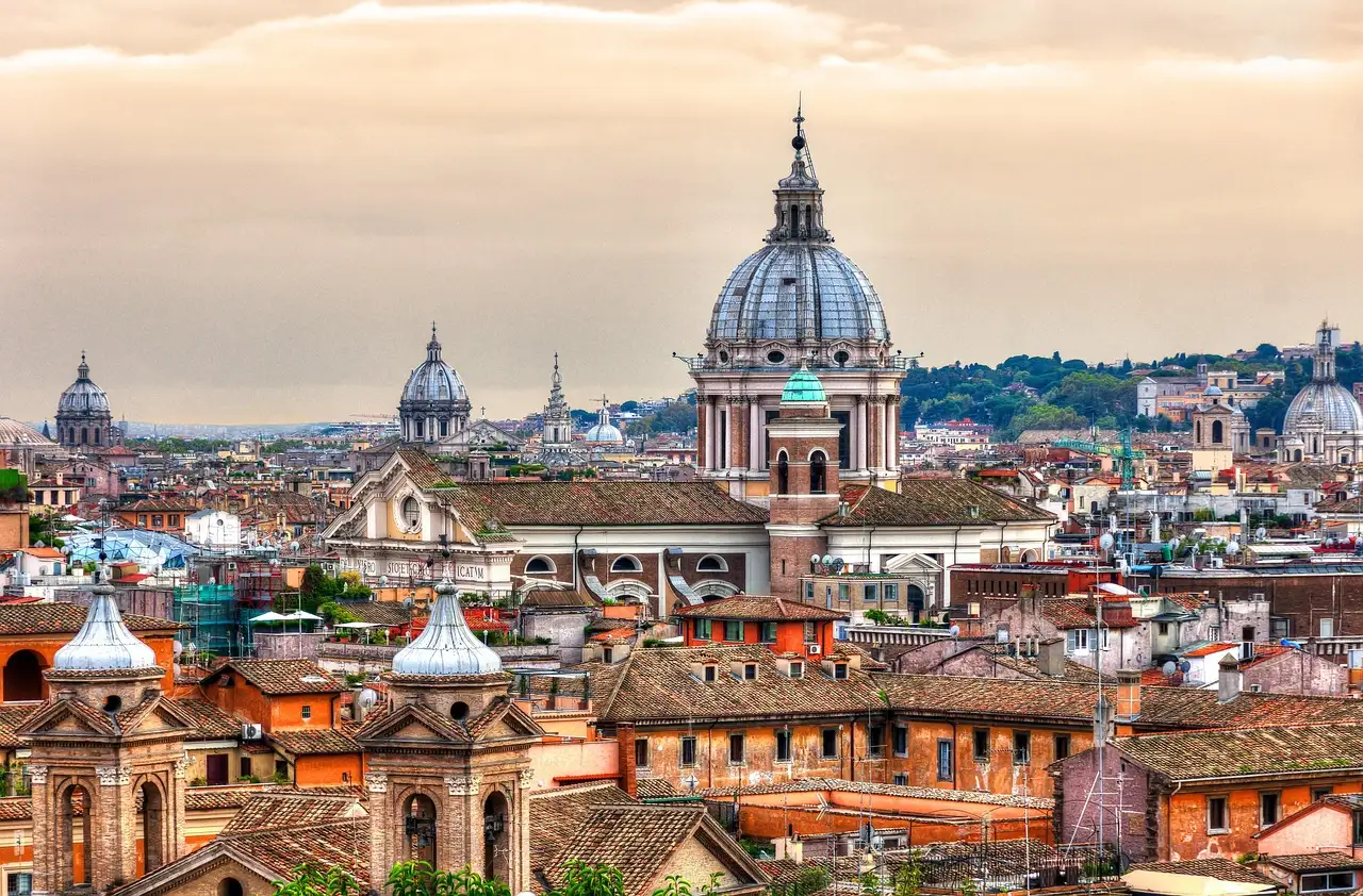 Rome rooftops and church domes in warm evening light