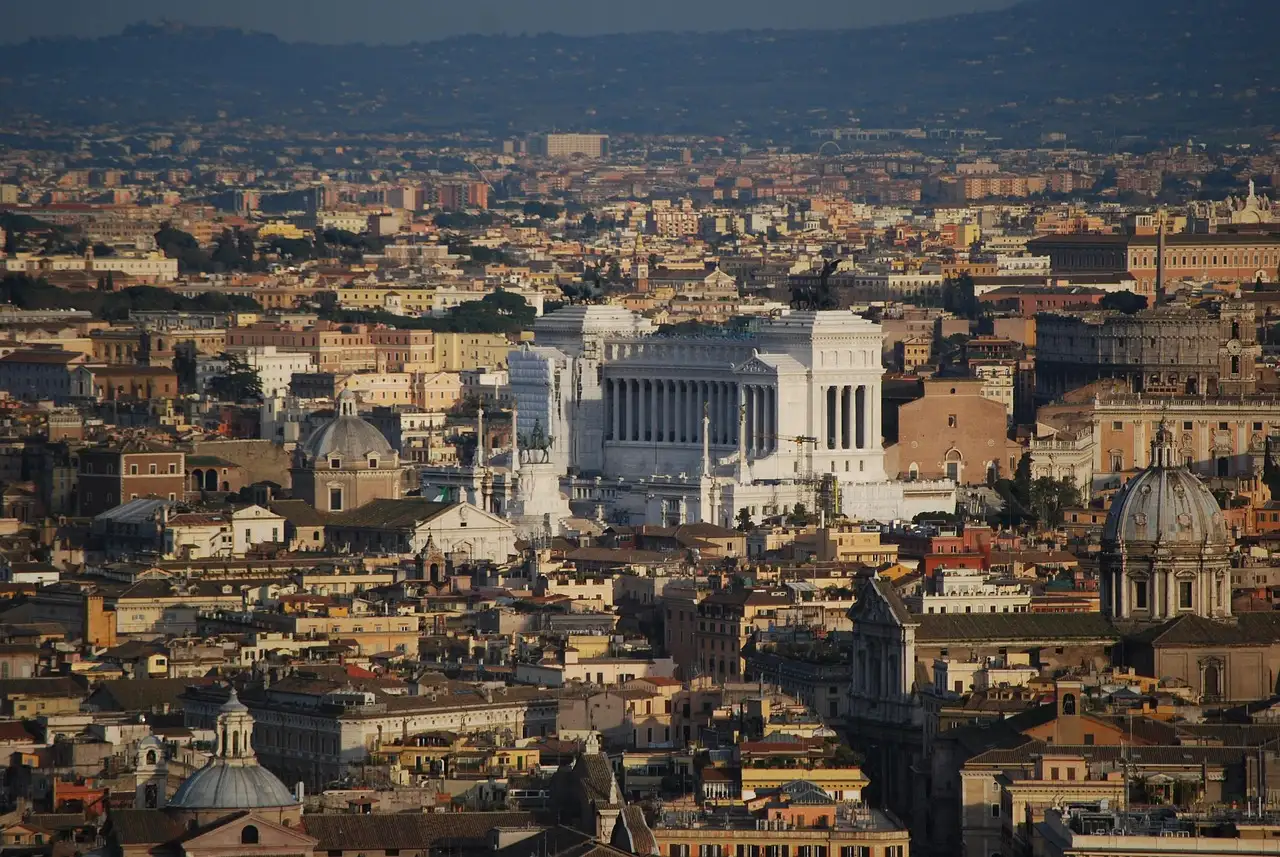 Rome rooftops and domes with the white Vittoriano monument in the middle