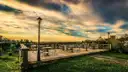 An empty viewing terrace with a street lamp above Rome at sunset
