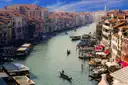 The Grand Canal in Venice seen from above, with a gondola and palaces along the water