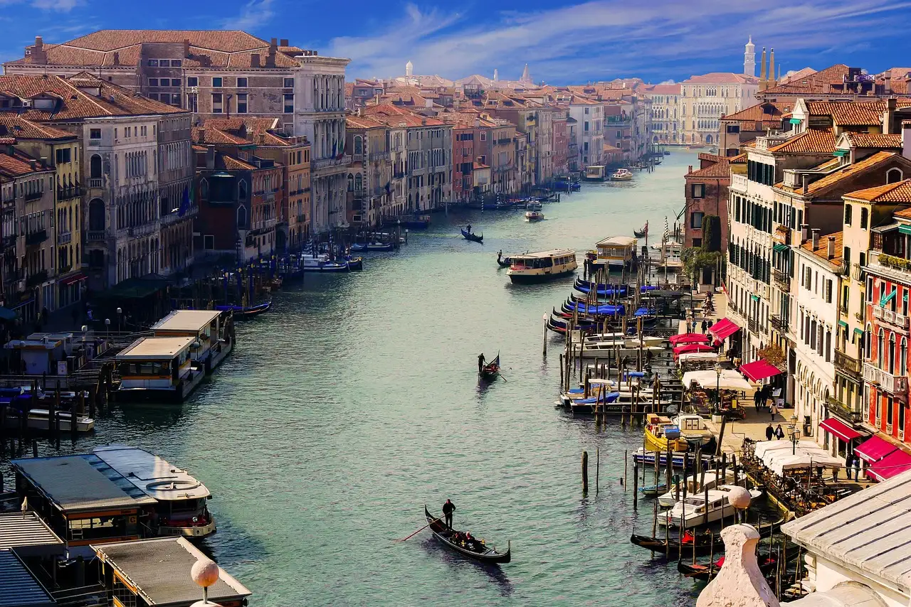 The Grand Canal in Venice seen from above, with a gondola and palaces along the water