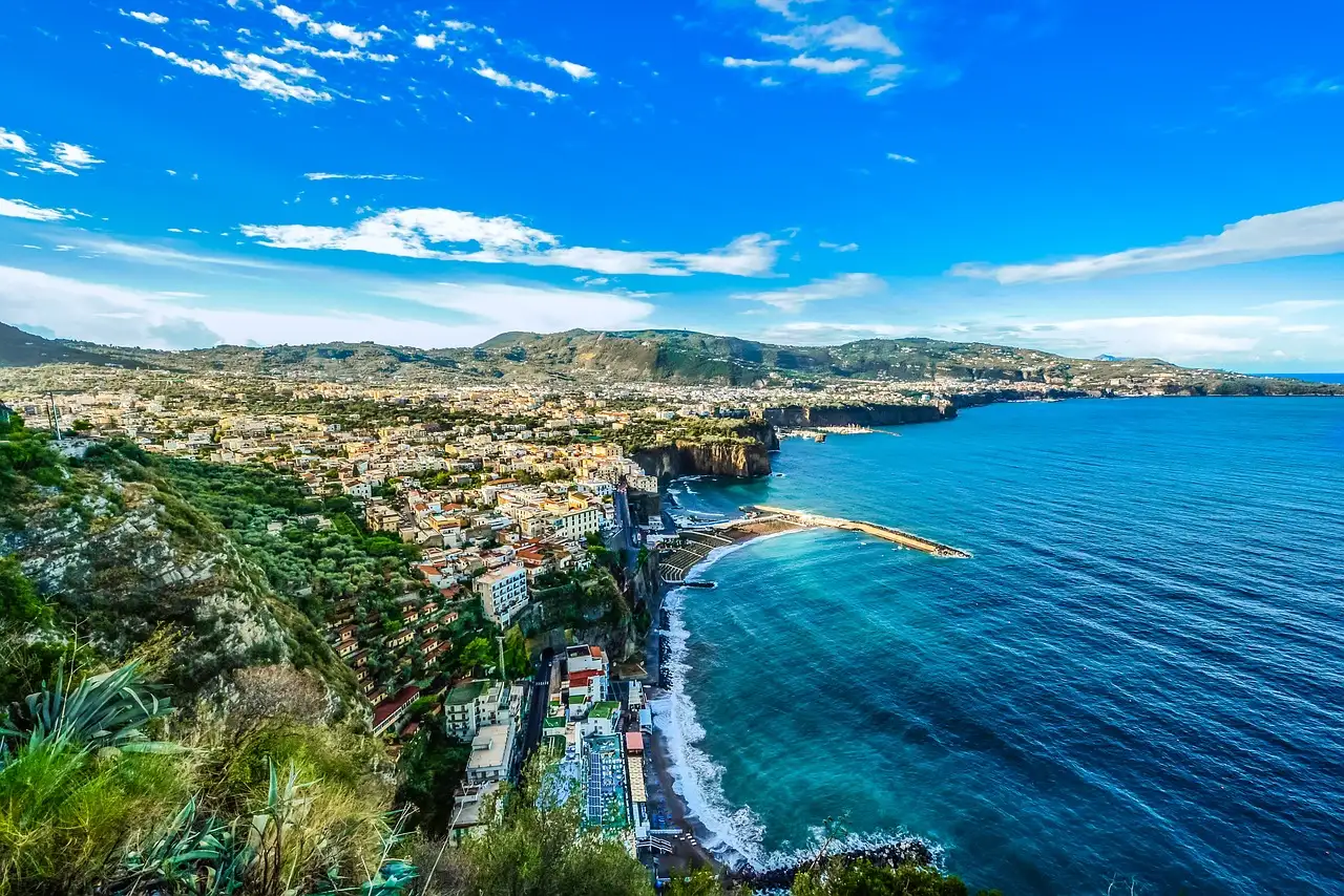 The coast near Sorrento from above, with the town by a deep blue sea