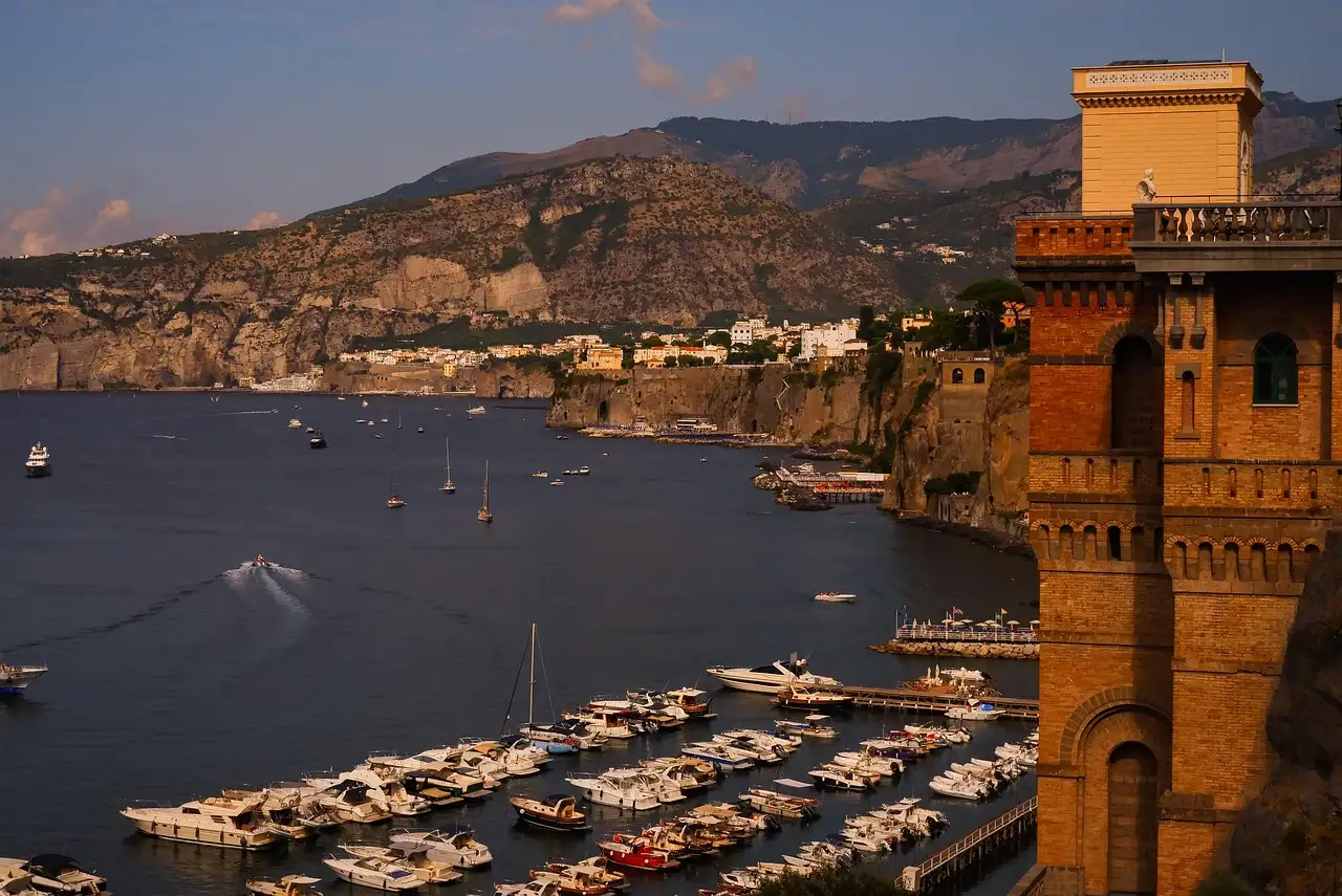Boats in the harbor at Sorrento at dusk, below the cliffs
