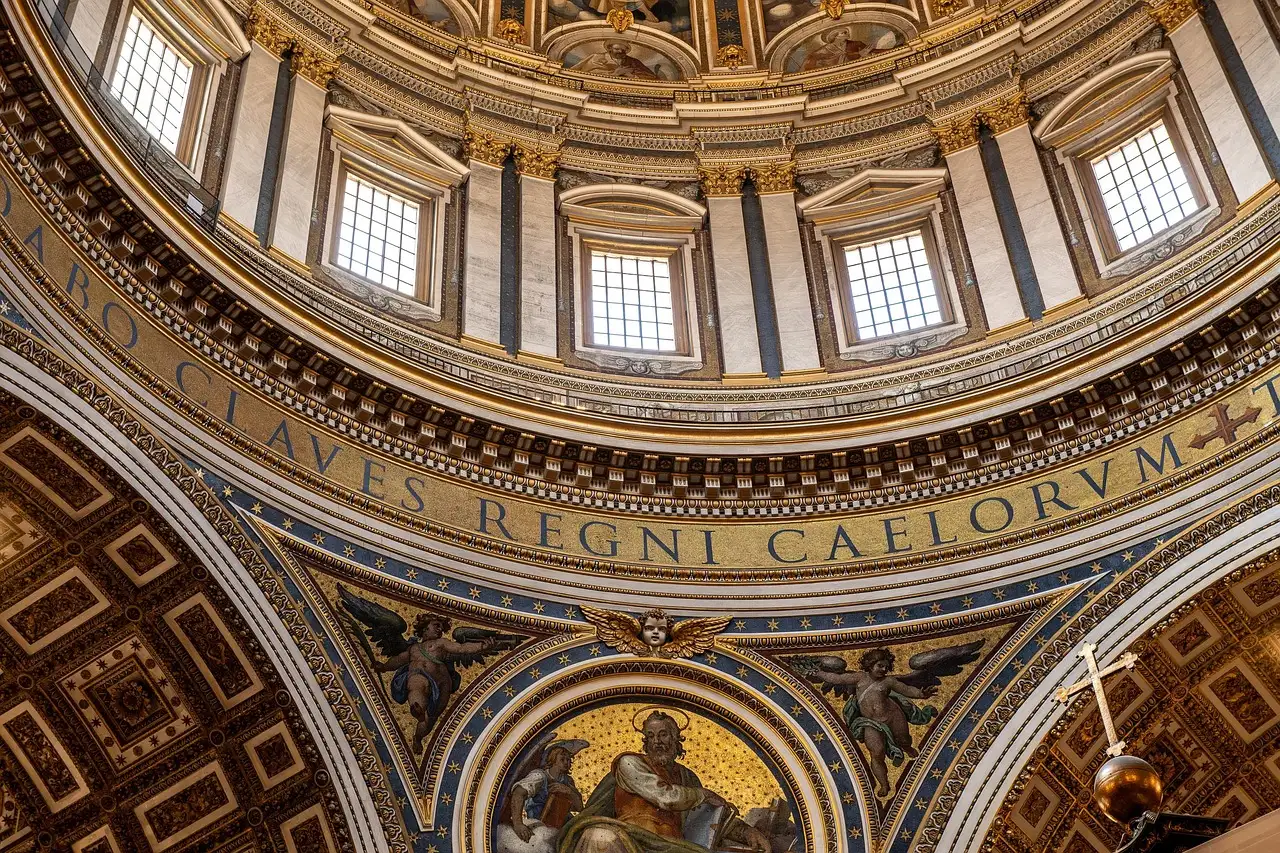 Looking up into the gold and white dome inside St. Peter's Basilica