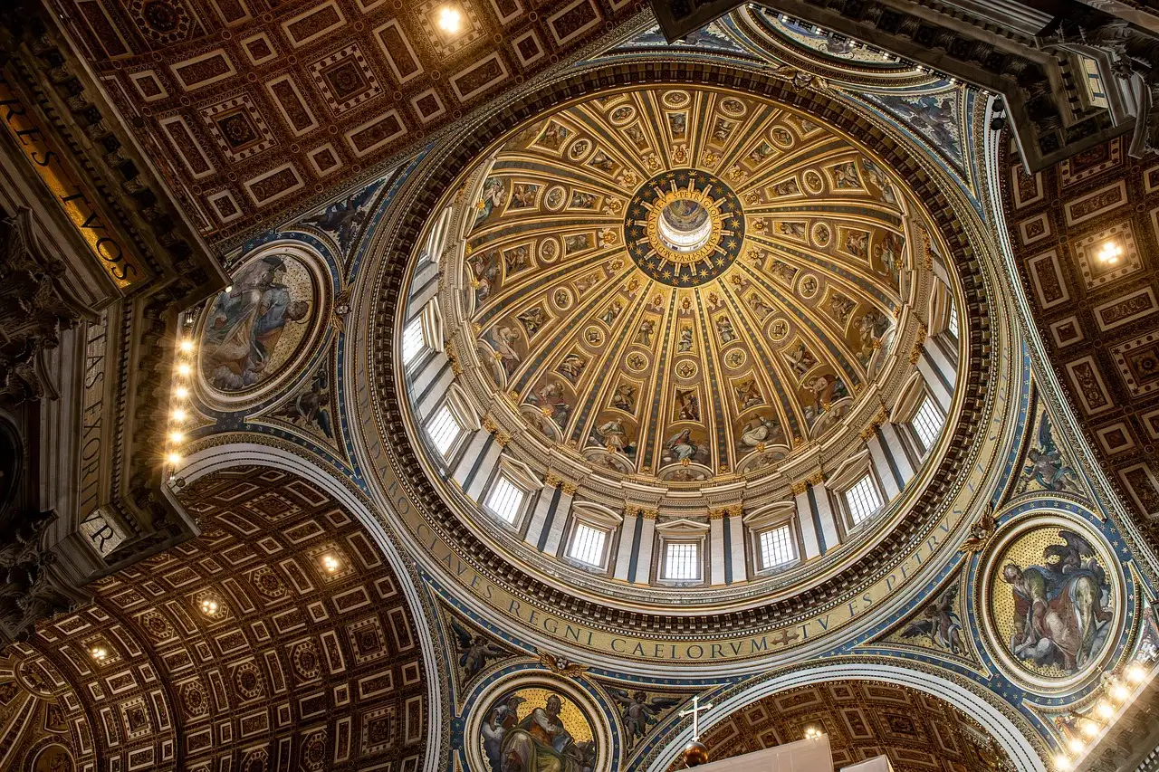 The inside of St. Peter's dome seen from below, with gold and coffered panels