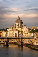 The dome of St. Peter's rising above a bridge on the Tiber