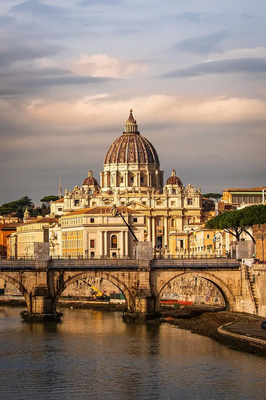 The dome of St. Peter's rising above a bridge on the Tiber