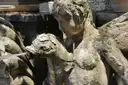 An old stone fountain statue in the gardens of Villa d'Este in Tivoli