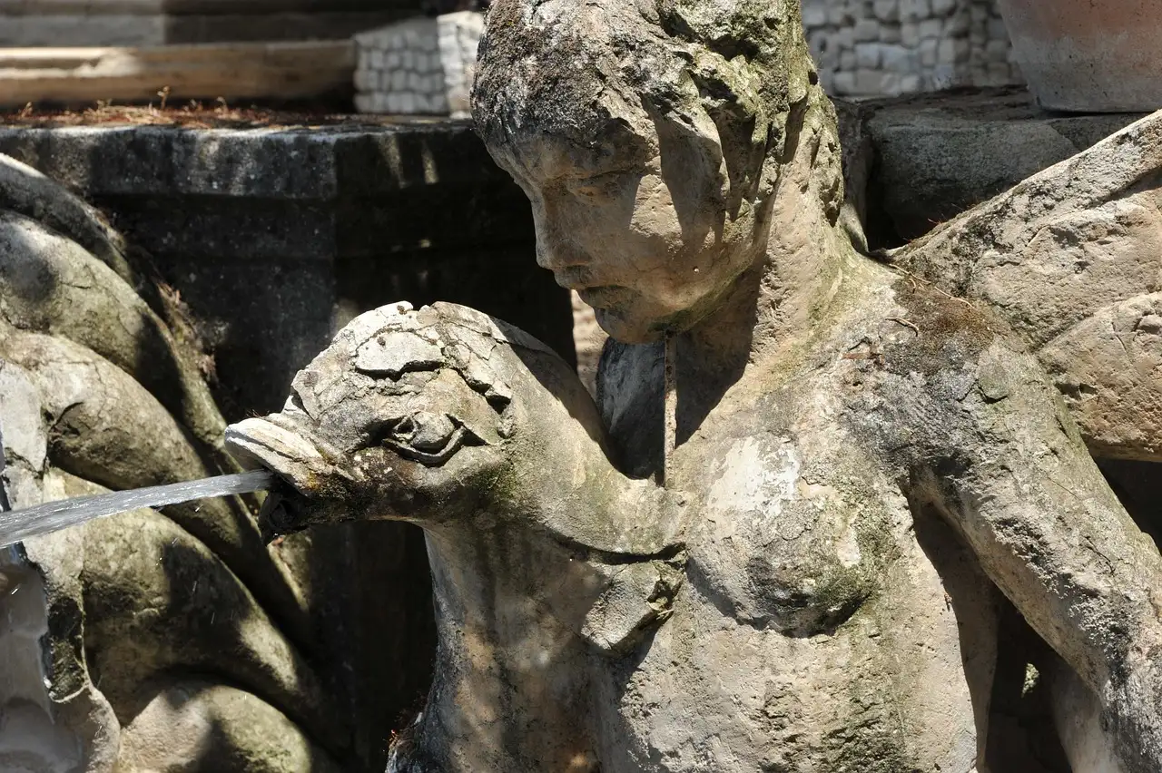 An old stone fountain statue in the gardens of Villa d'Este in Tivoli
