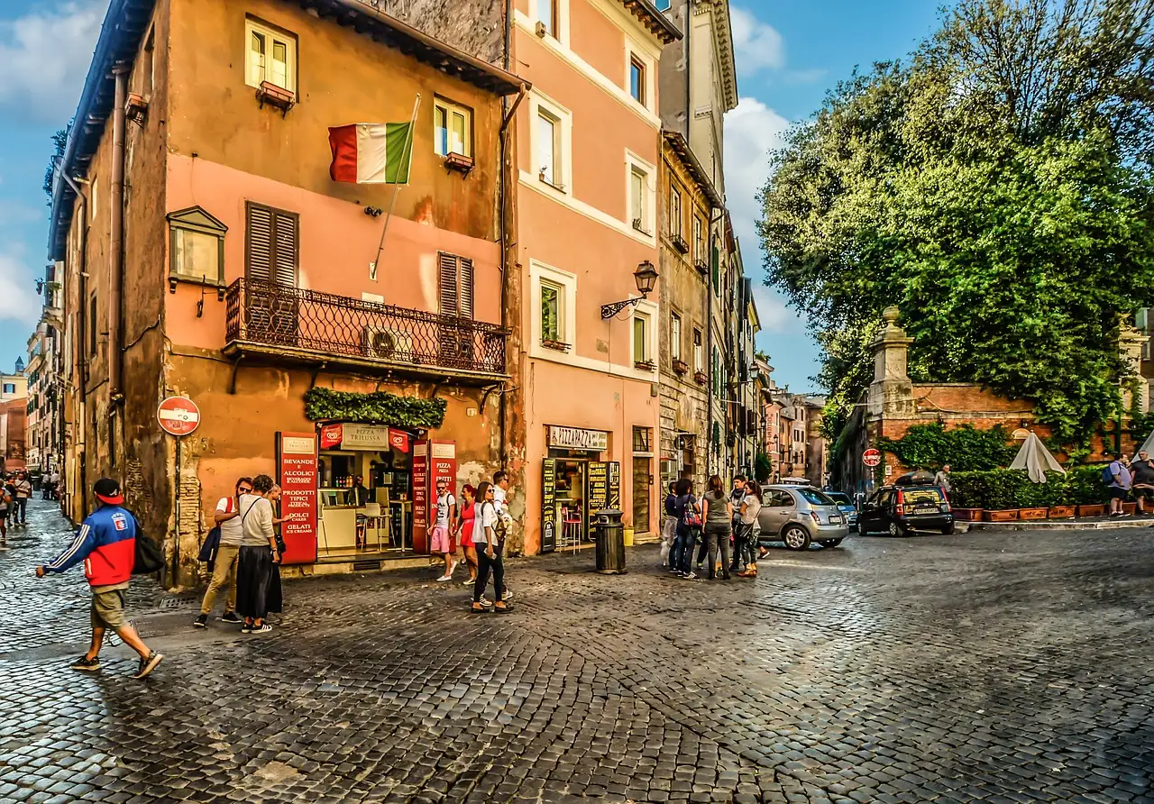 A cobbled street with cafes and old houses in Trastevere, Rome