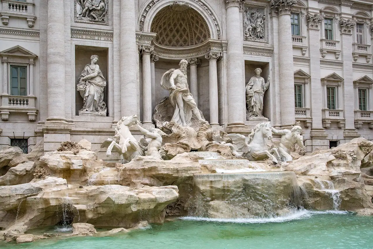 The Trevi Fountain in Rome with its statues and pale blue water