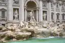 The Trevi Fountain in Rome with its statues and pale blue water