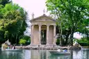 The small temple on the lake in Villa Borghese, with rowing boats on the water